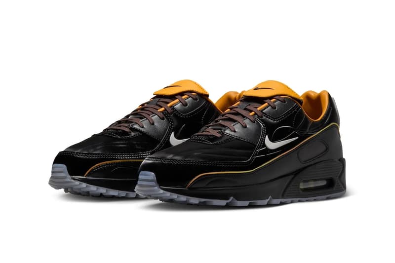 Chaussures de sport noires et orange avec semelles transparentes.